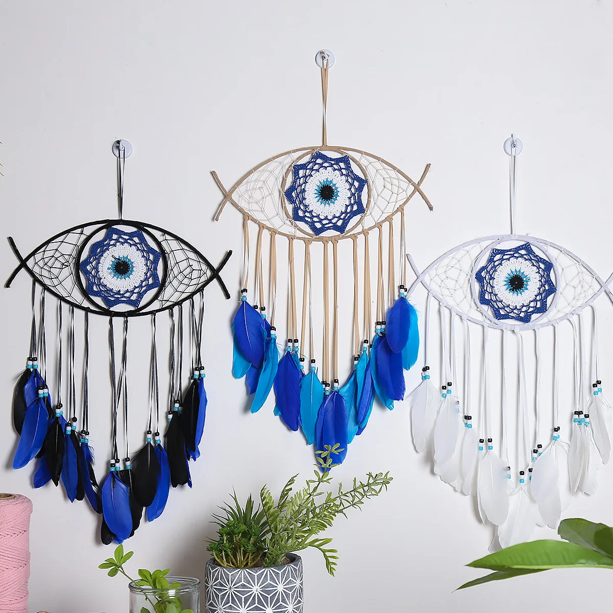Evil eye dream catcher with blue feathers, product photo
